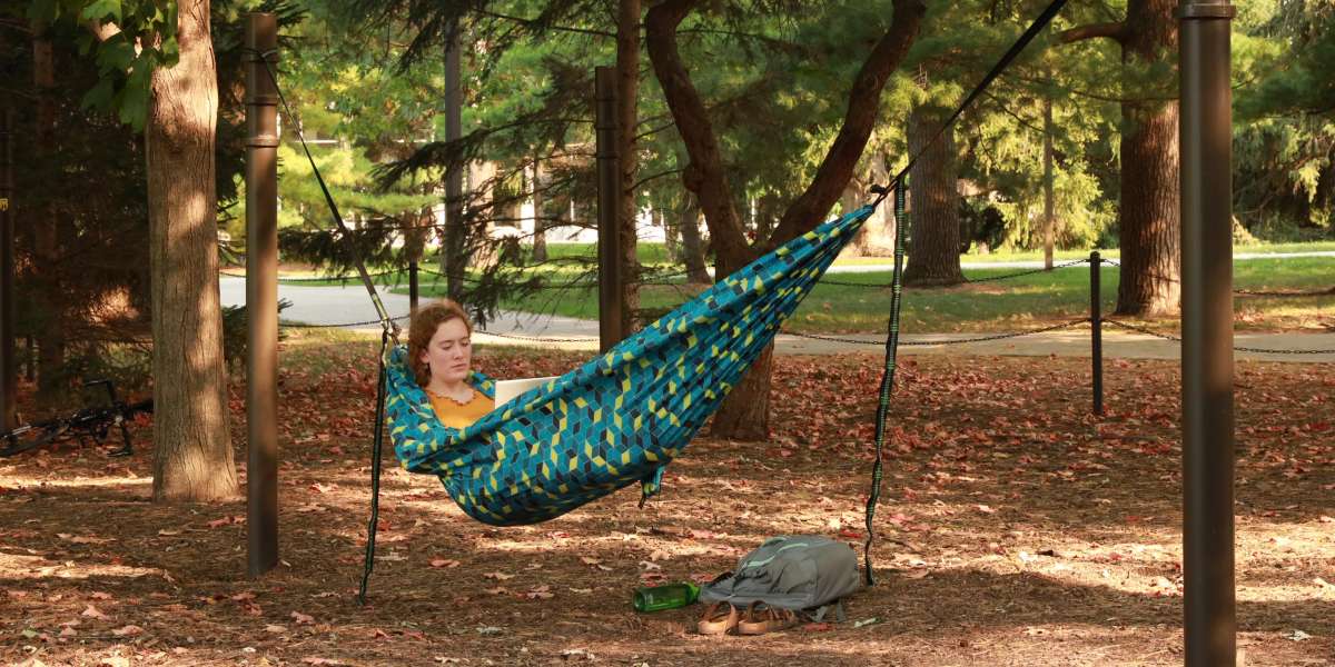 Girl sitting in teal hammock