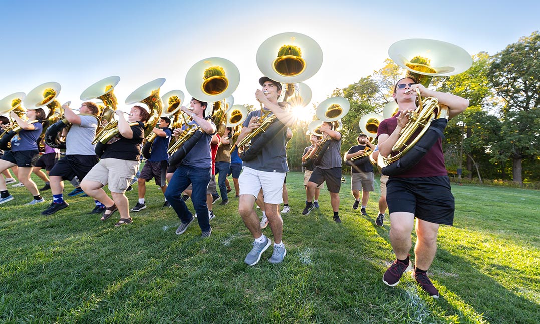 The tuba section of the marching band at practice.