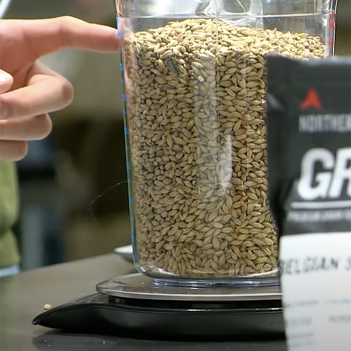 Close up of brewing grains in a glass container.