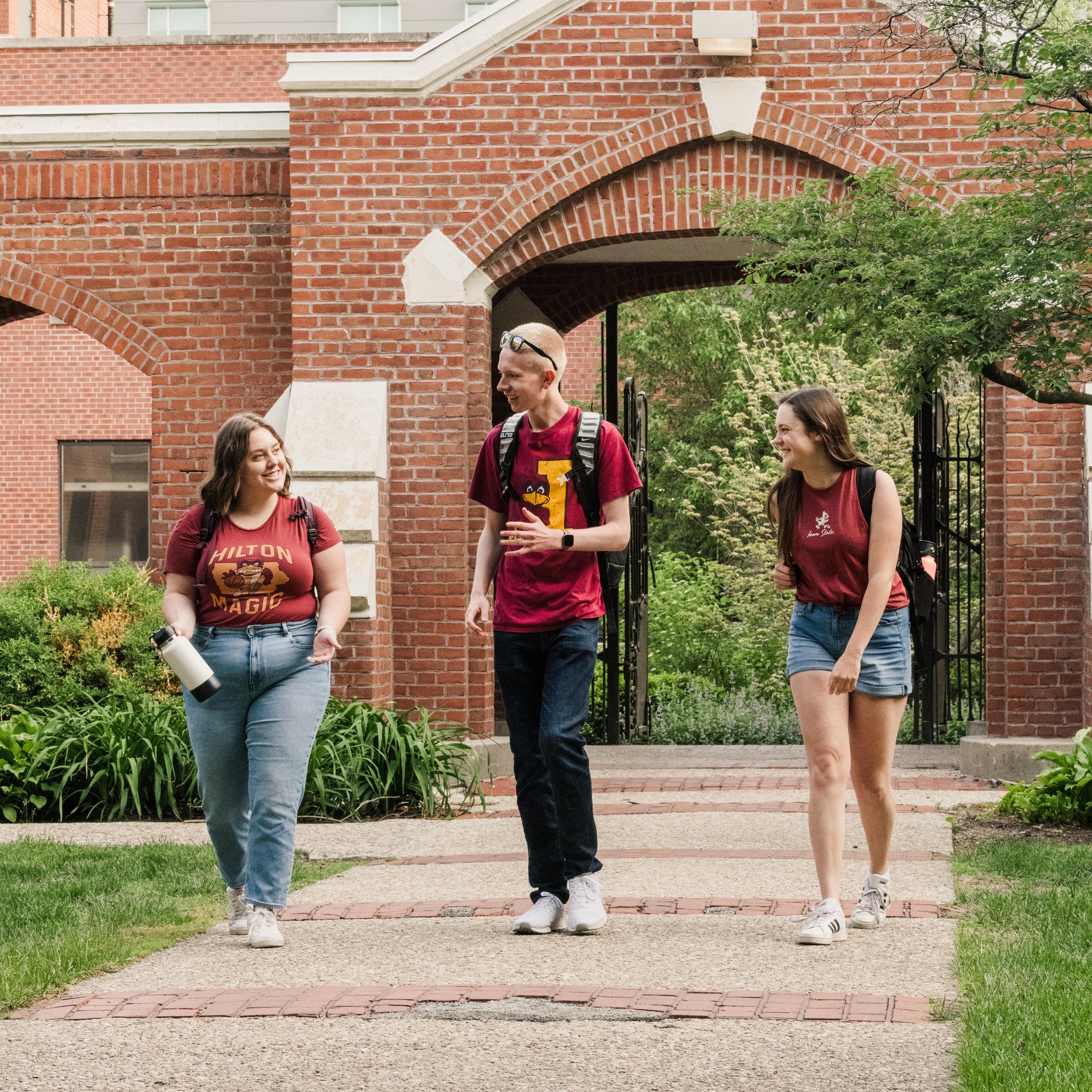 Three students walking in front of Lagomarcino Hall