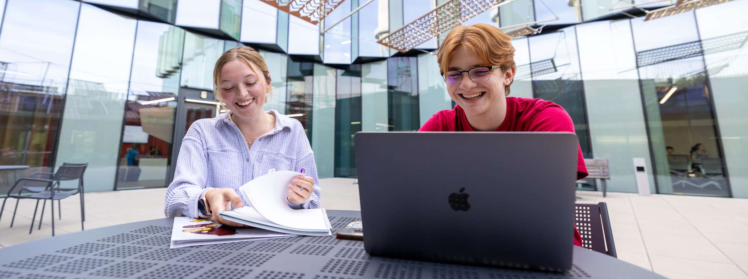 Two students studying in the Student Innovation Center Courtyard