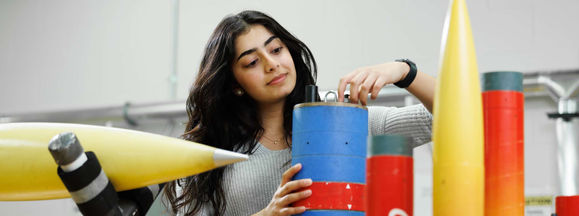 A student works on a rocket project