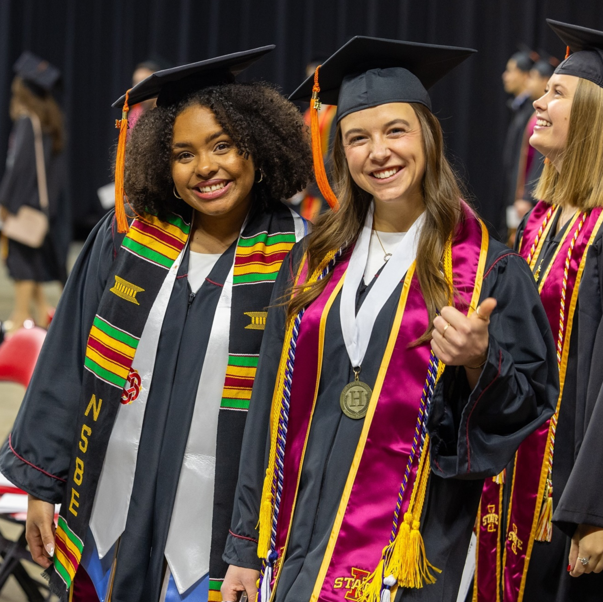 Two students celebrating graduation