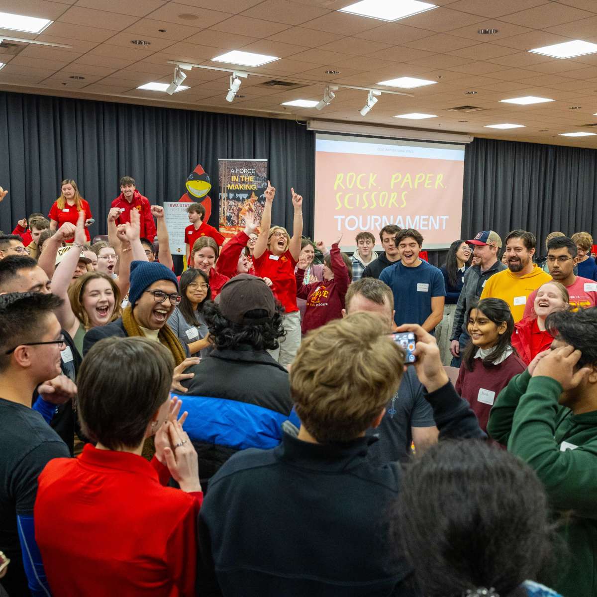 A group of students participate in a rock, paper, scissors tournament during Destination Iowa State